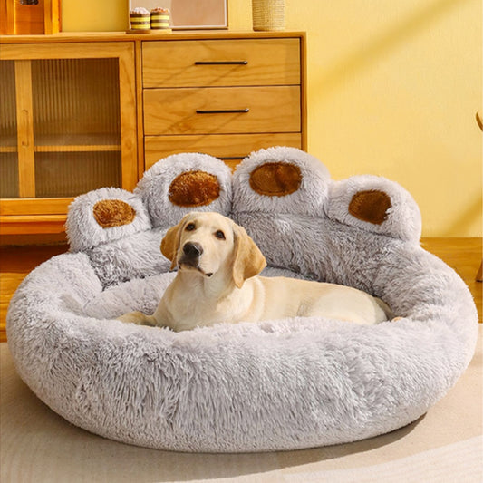 Labrador laying on gray paw shaped dog bed