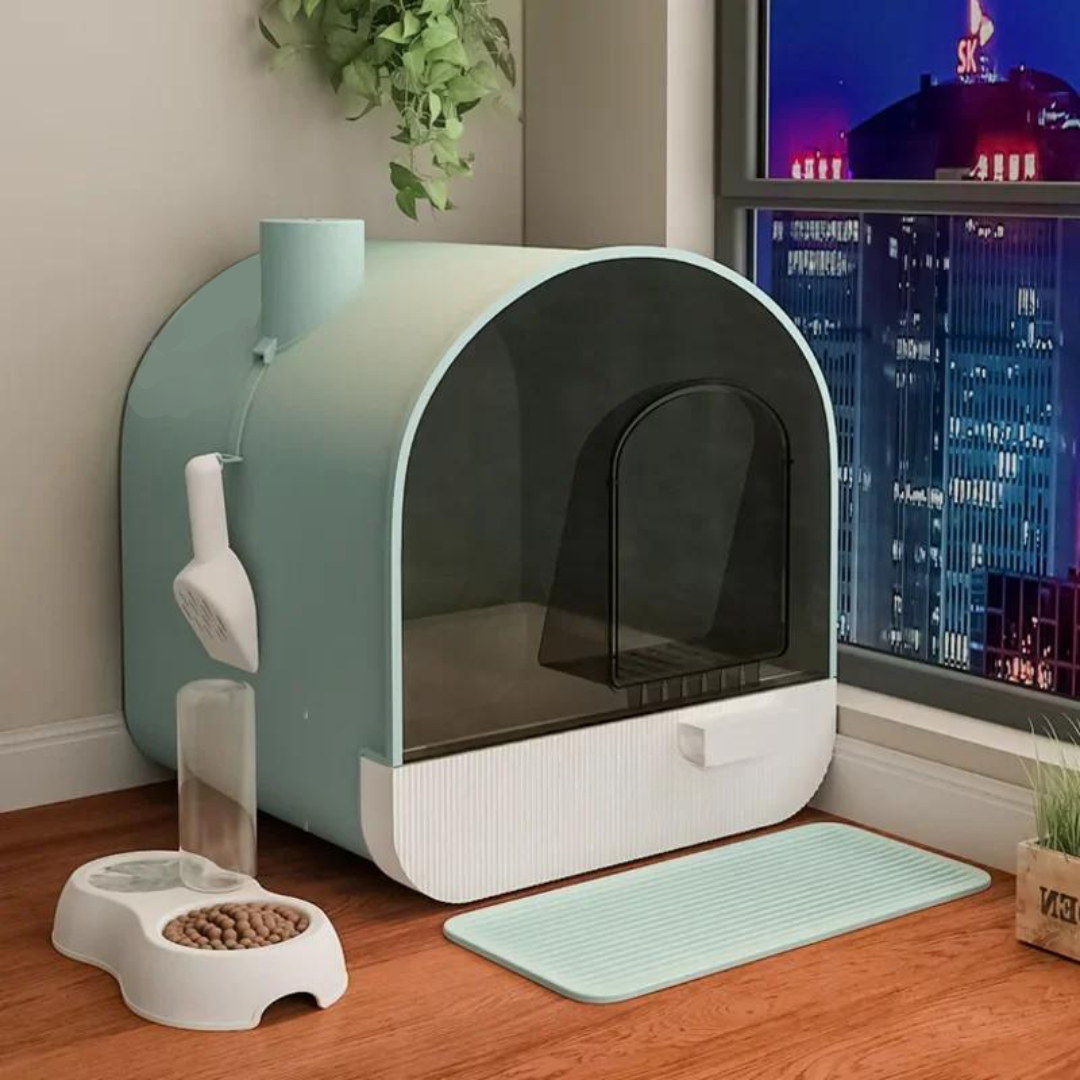 Green enclosed cat litter box with attached scooper and deodorizing chimney