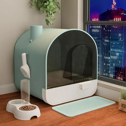 Green enclosed cat litter box with attached scooper and deodorizing chimney