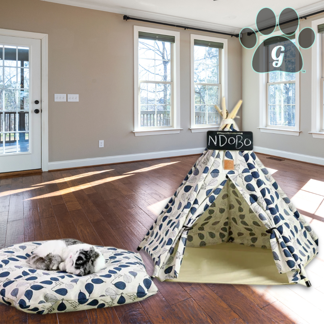 white pet tipi tent with blue leaves and pillow removed shown in large empty room