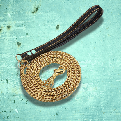 gold chain link dog leash with leather handle.