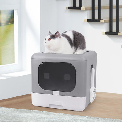 gray enclosed litter box with attachable scooper and cat sitting ontop