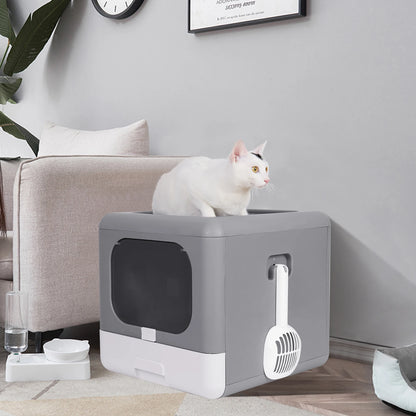 gray enclosed litter box with attachable scooper and cat sitting ontop