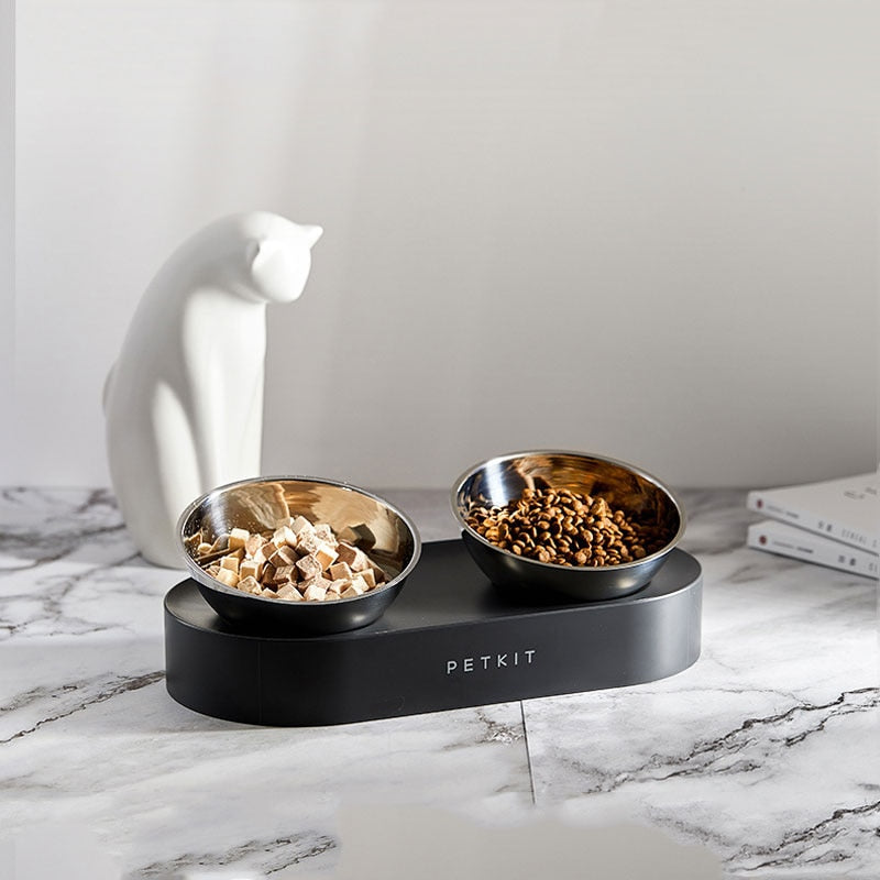 stainless steel bowls containing food on black base 