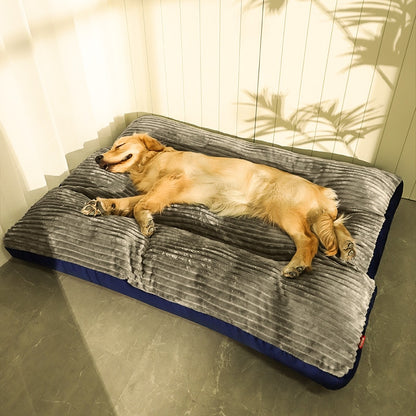 golden retriever laying on gray and blue corduroy dog bed