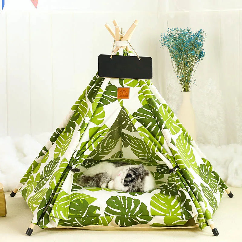 white 5 sided pet tipi tent with green tropical leaves print and cat sleeping inside