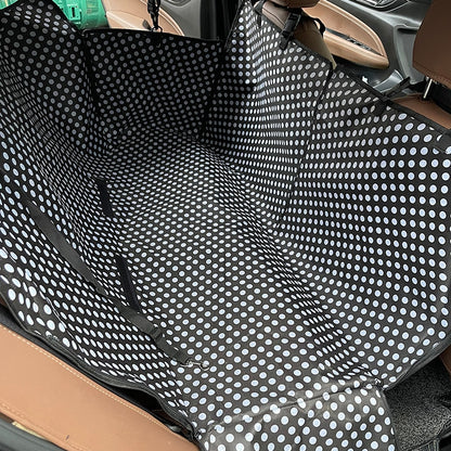 Back seat automotive pet cover in black with white polka dot prints.