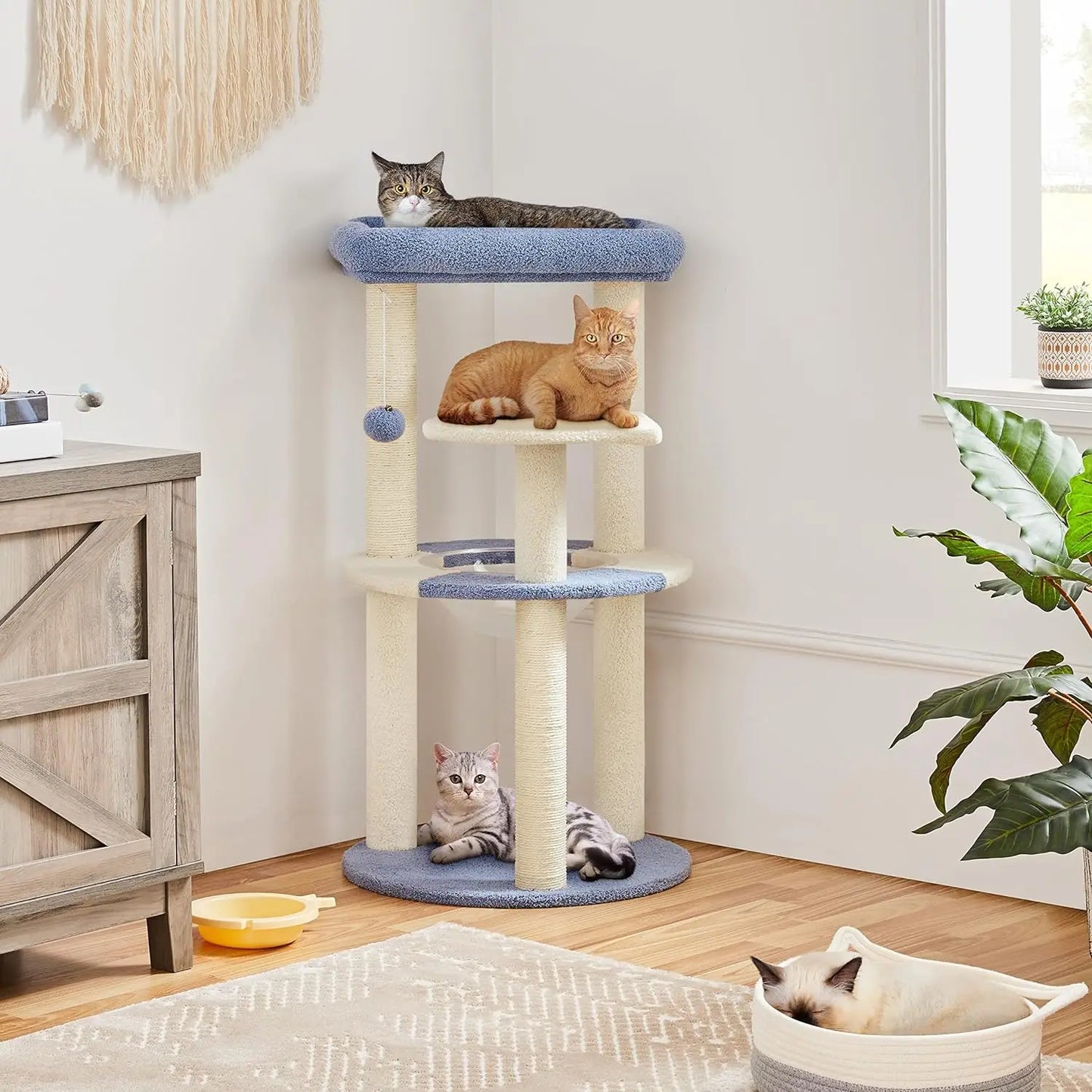 blue plush cat tower with multiple cats on various levels