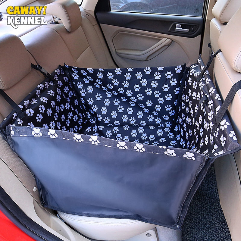 Single seat automotive pet carrier in black with white paw prints, shown fully zipped in the back seat.