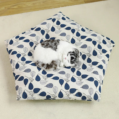 removable pillow for white pet tipi tent with blue leaves shown with cat on top