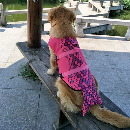 golden retriever dog wearing mermaid style lifejacket and sitting atop a bench