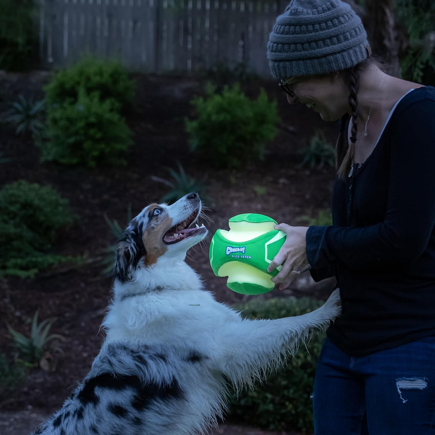 woman playing fetch with dog